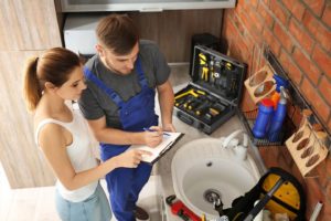 A professional plumber helping a client understand plumbing issue Springfield Illinois.
