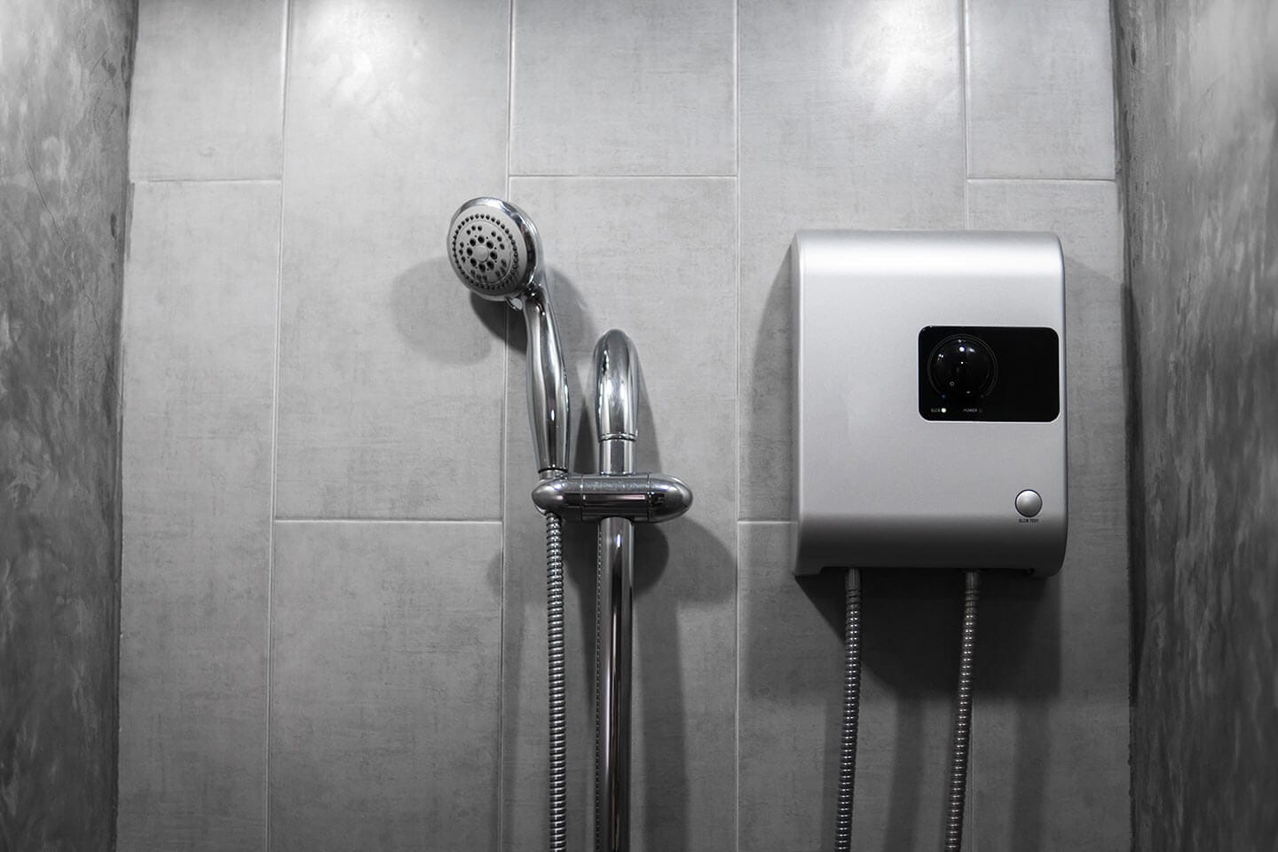 A tankless water heater to the right of a shower head in Springfield, Illinois.